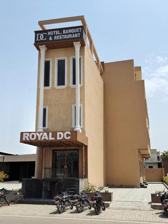 a row of motorcycles parked in front of a building at Hotel ROYAL DC in Alīgarh