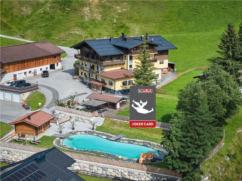 an aerial view of a resort with a swimming pool at Eibinghof BED & BREAKFAST & SWIM Frühstück Pension in Saalbach-Hinterglemm