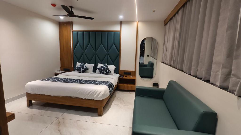 a hotel room with a bed and a couch at Mojo stay hotel in Ahmedabad