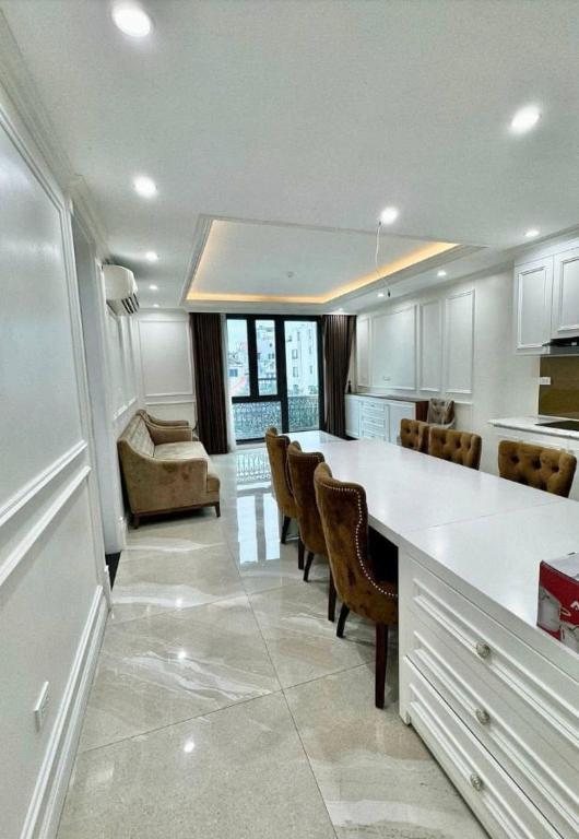 a kitchen with a table and chairs and a couch at Buthaina Royal Resort in Bidbid