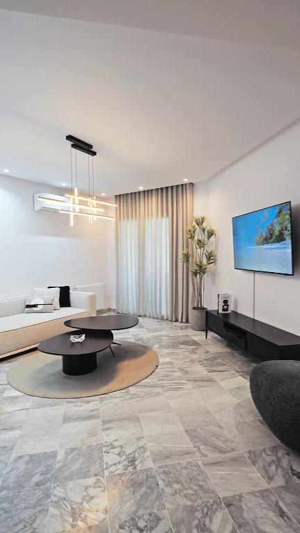 a living room with a table and a couch at chez moi sfax ville in Sfax