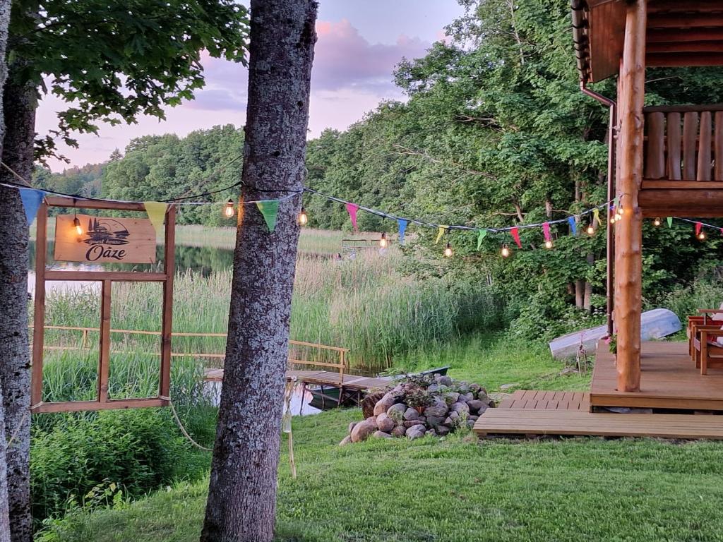 a yard with a tree and a string of lights at Guest house Oaze in Miglāni