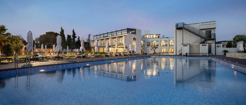 a large swimming pool next to a building at The Komana Dardanelles in Hamidiye