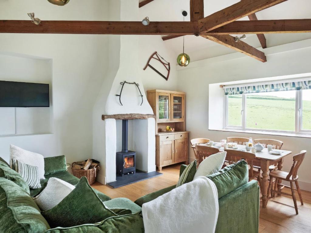a living room with a couch and a wood stove at Harvest - Ukc9523 in Barnstaple