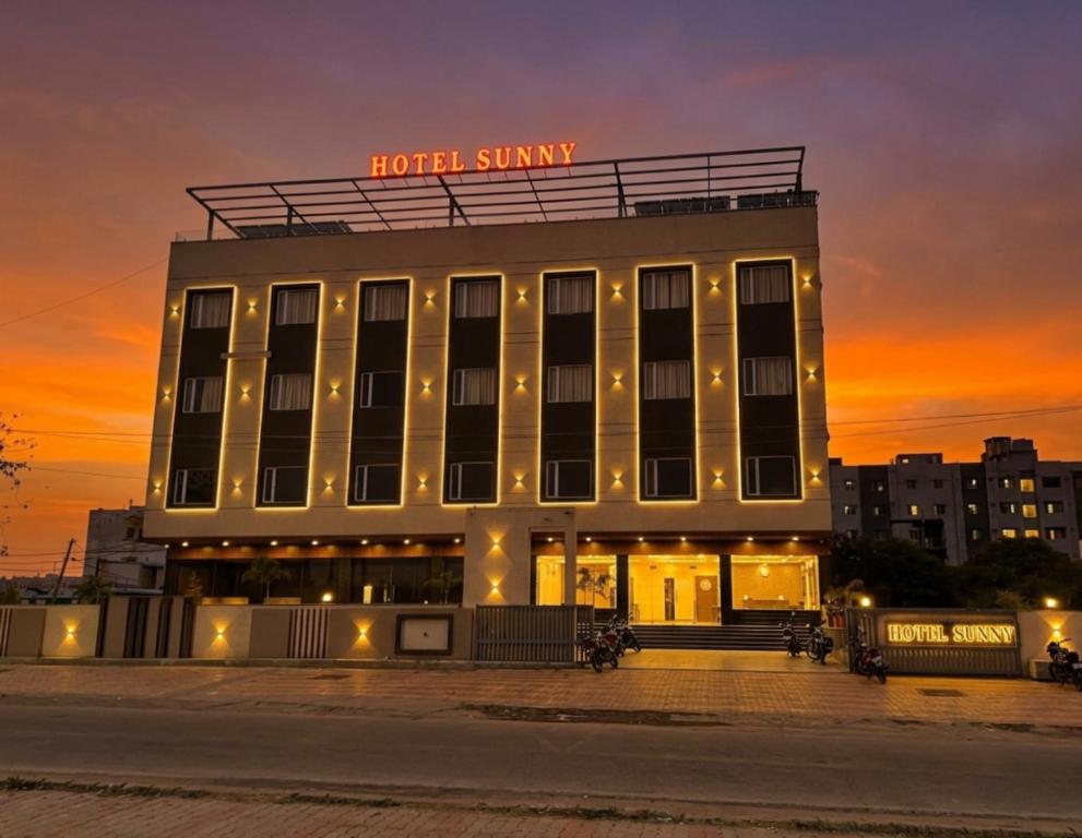 a hotel building with a sign on top of it at Hotel Sunny Jhalawar in Jhālāwār