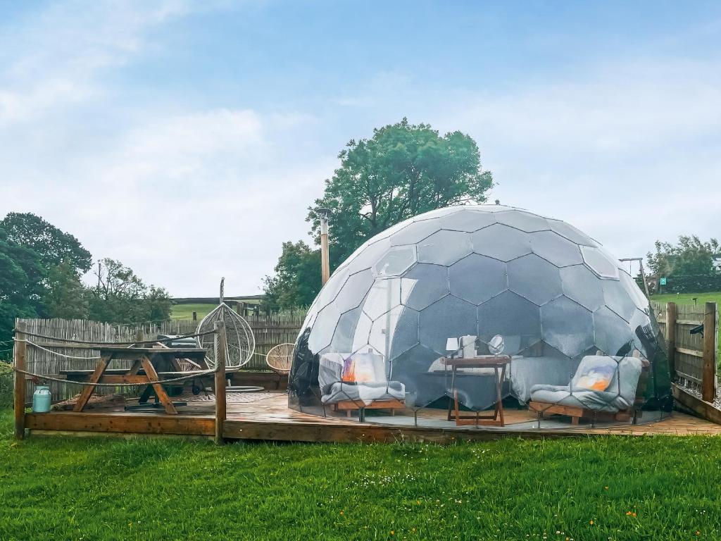a igloo with a table and chairs in a field at Pendle Hill Dome - Ukc9599 in Earby