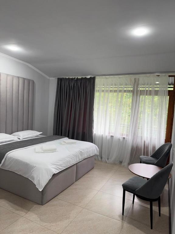 a bedroom with a bed and a table and chairs at Ararat hotel in Goris