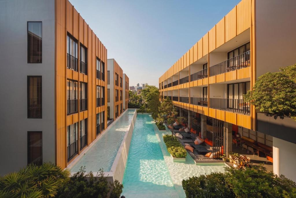 an overhead view of a swimming pool between two buildings at Craftsman Bangkok in Bangkok