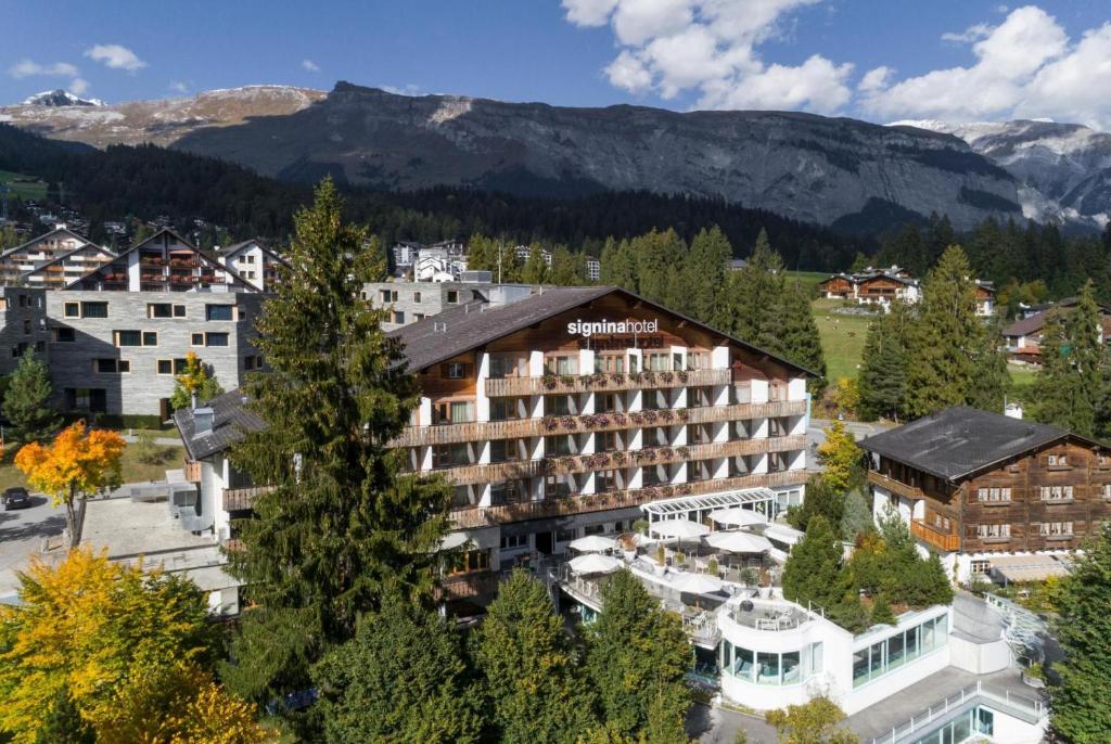 a hotel in a town with mountains in the background at signinahotel in Laax
