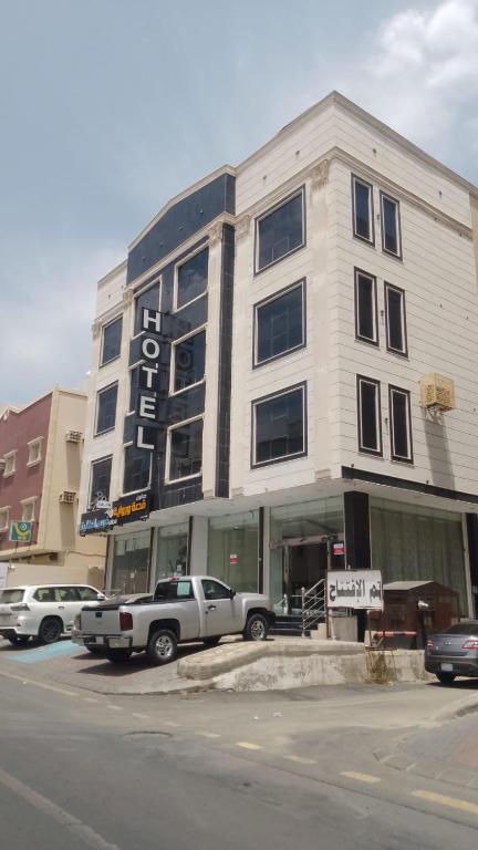 a white truck parked in front of a building at فرس ابها - شقق مفروشه in Abha