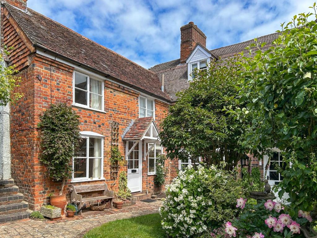an old red brick house with a garden at Militia Cottage in Marlborough