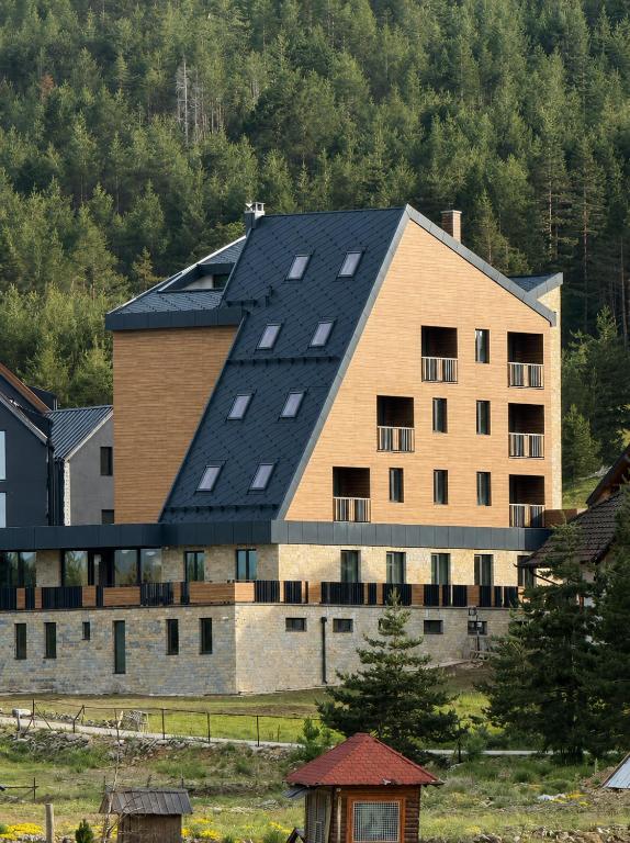 a large building with a black roof at Hotel O2 Tornik in Ribnica