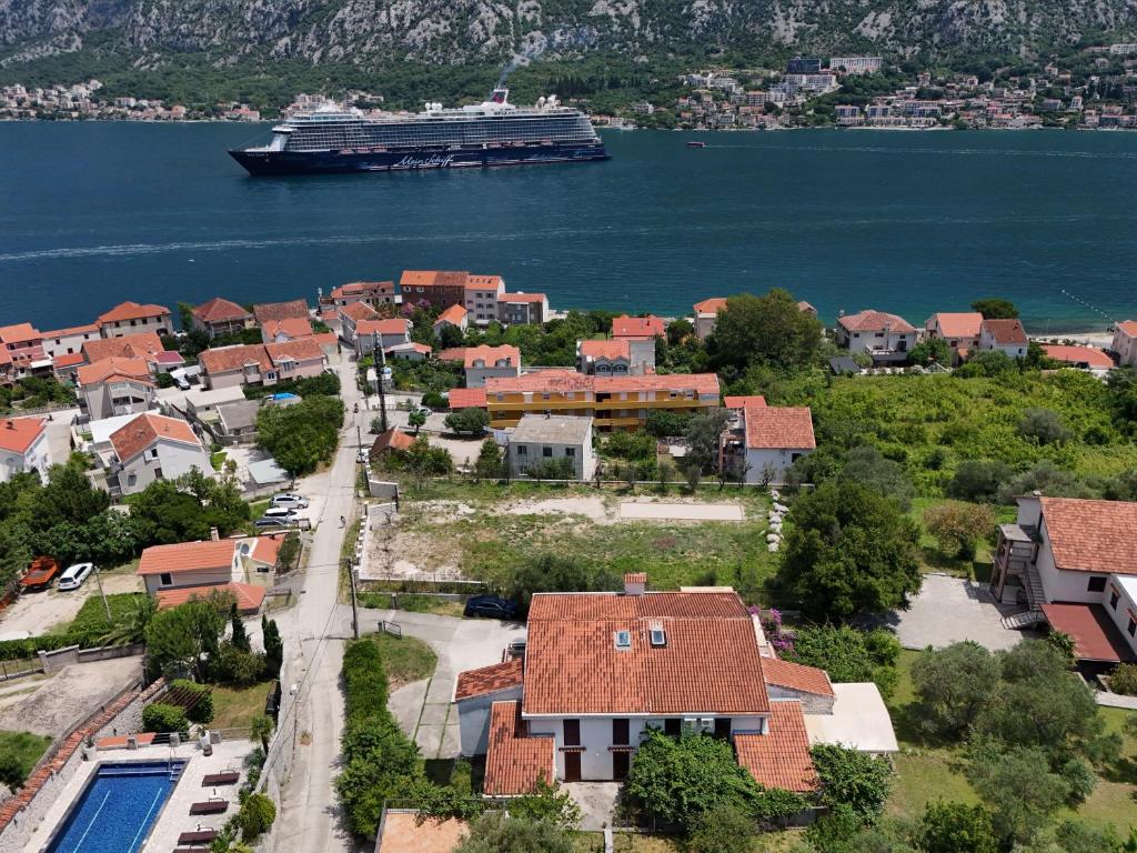 a cruise ship in the water next to a city at Villa Four-bedroom Prcan Kotor in Prčanj