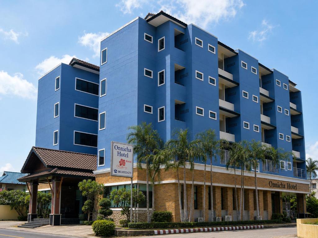 a blue apartment building with a gazebo at Onnicha Hotel Phuket in Phuket