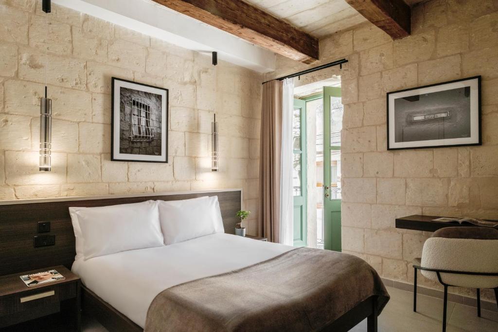 a bedroom with a large white bed and a window at Casa Radiant in Rabat