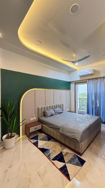 a bedroom with a large bed and a green wall at Om Sai Ram Hotel in Rājūra