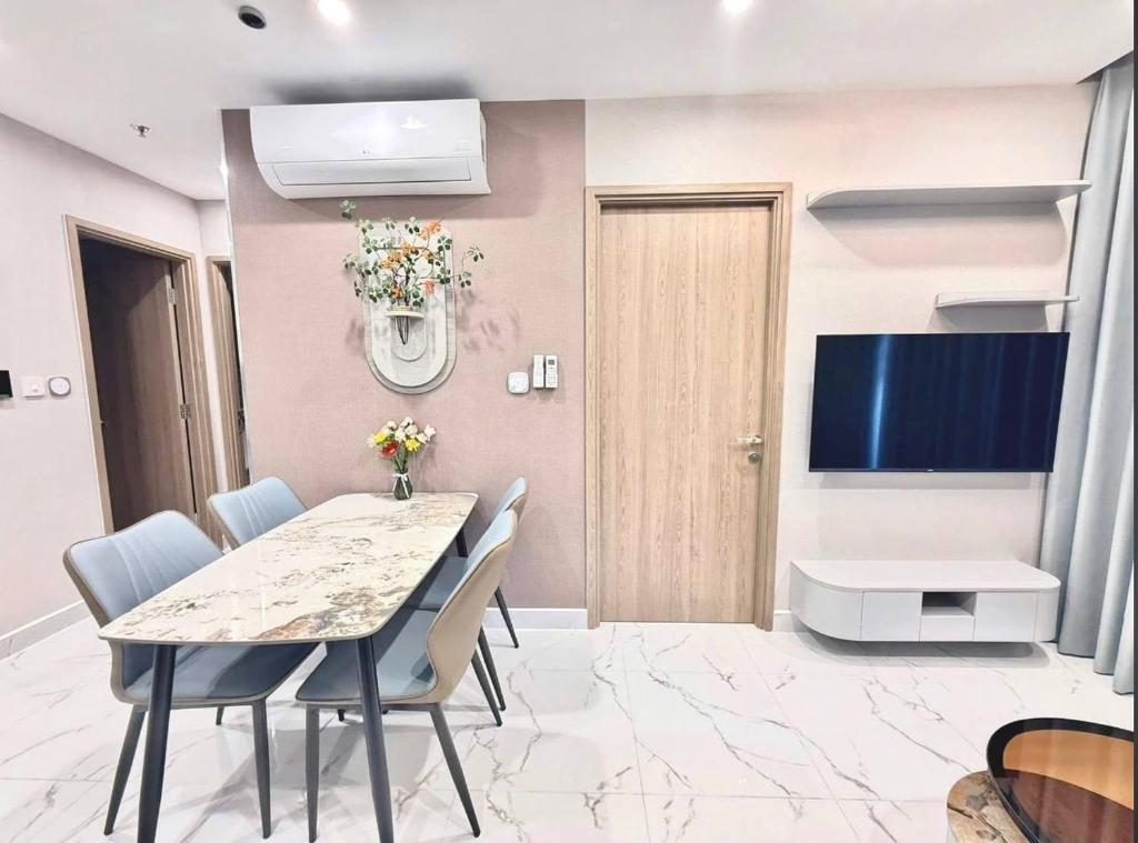 a dining room with a table and chairs and a tv at Bristol Court in Kathmandu
