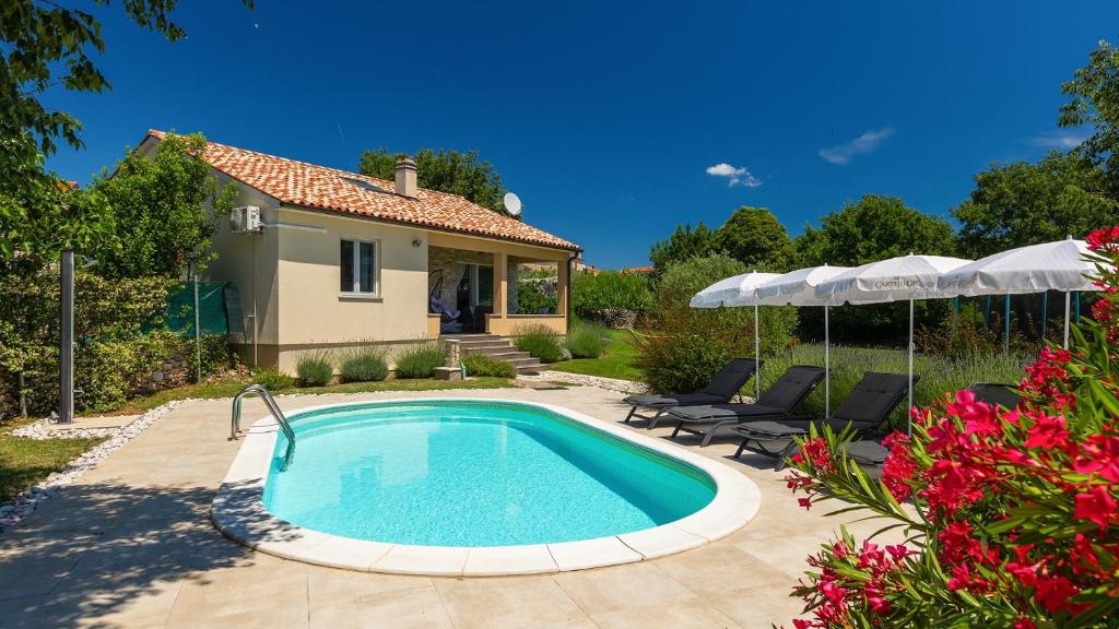 a swimming pool in a yard with a house at Villa MA by Villas Guide in Vodnjan