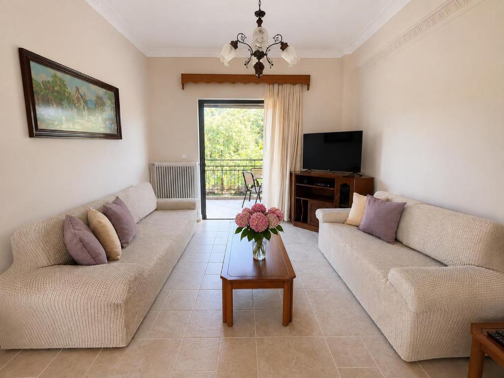 a living room with two couches and a table at Dimitris house in Parga