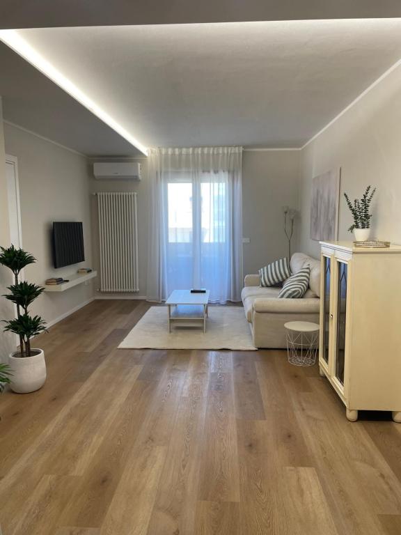 a living room with a couch and a table at Guest House 36 private parking in Orbetello