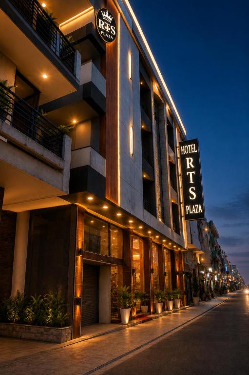 a hotel with a sign on the side of a building at Hotel The RTS Plaza in New Delhi
