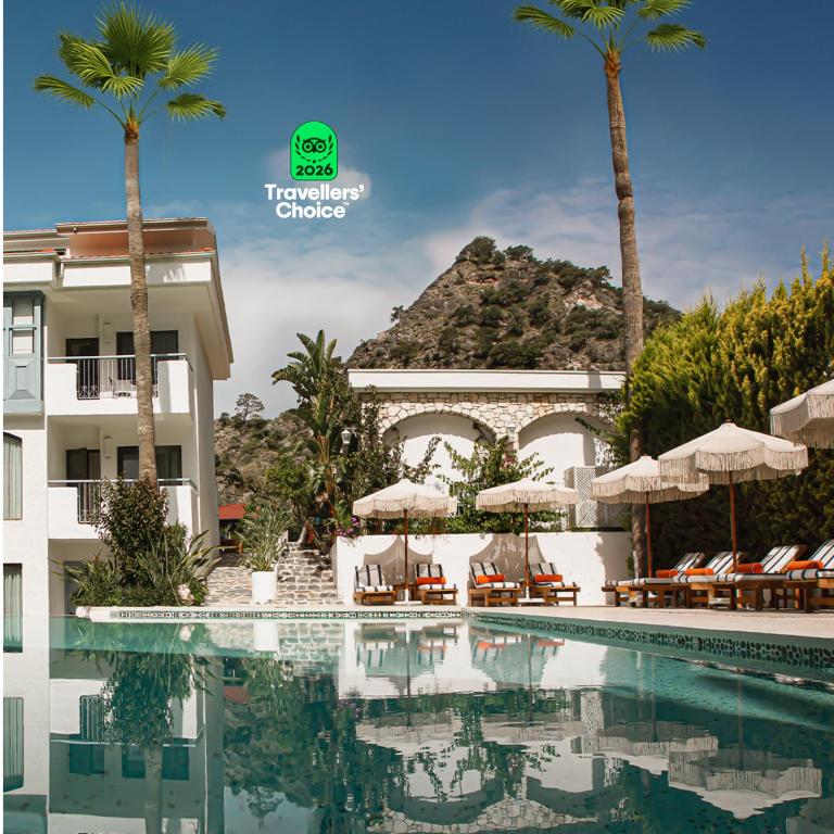 a resort with a swimming pool and palm trees at Kassandra Oludeniz in Oludeniz