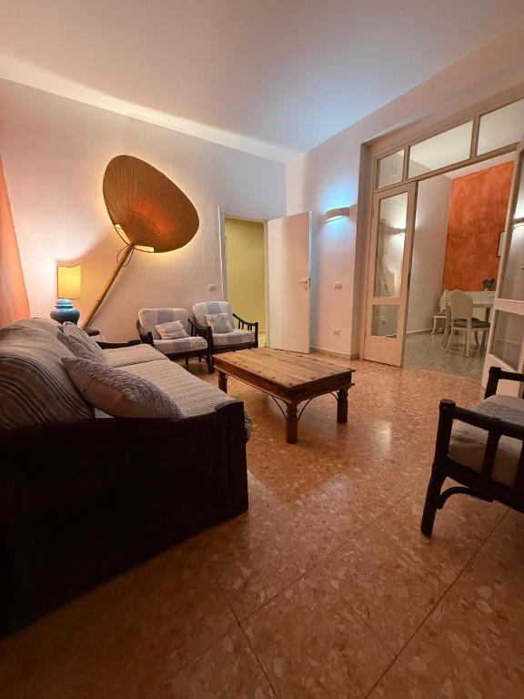 a living room with a couch and a coffee table at Orange Home in Olbia