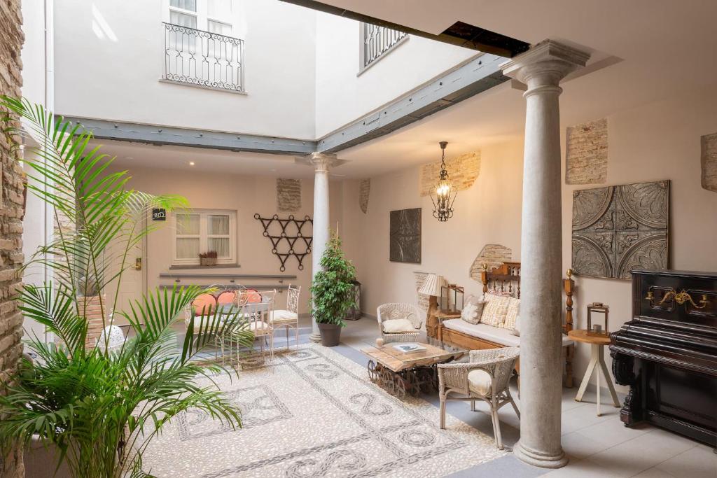 a living room with a couch and a piano at Apartamentos Luna Suites Palacio Almagra in Granada