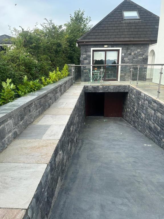 a retaining wall in front of a house at The River Nook in Termonbarry