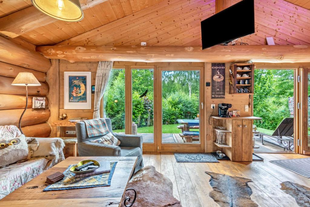 a living room with a couch and a tv at Ferienhütte 15 in Sankt Englmar