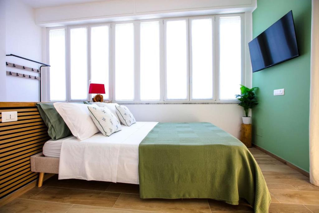 a bedroom with a bed and a large window at Pole Pole - NATURA in Agropoli