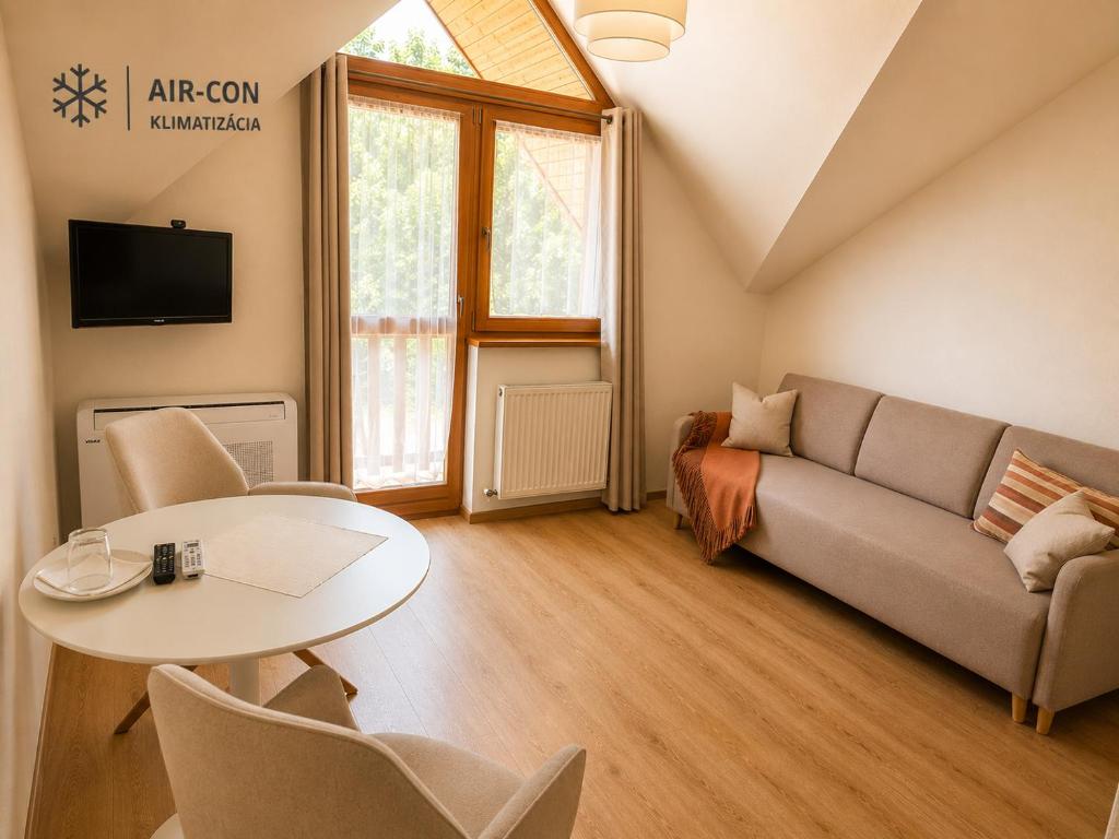 a living room with a couch and a table at Penzion Centrum in Sklené Teplice