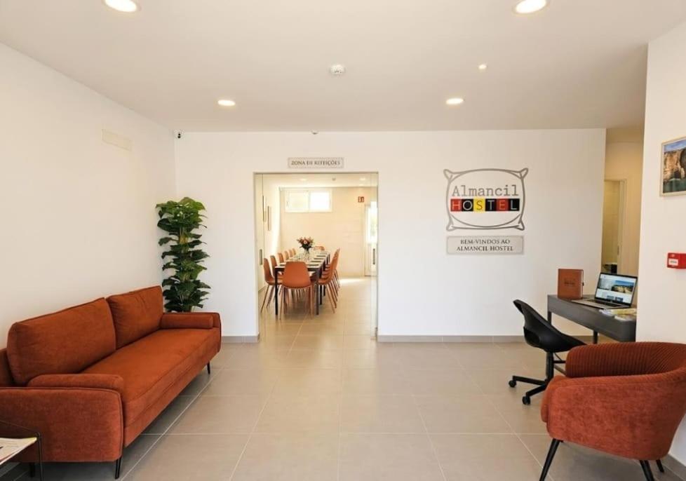 a living room with a couch and chairs and a table at Almancil Hostel in Almancil