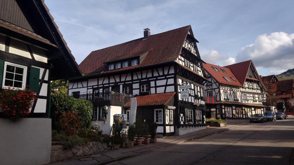 a row of black and white buildings on a street at Denkmal 1764 in Sasbachwalden