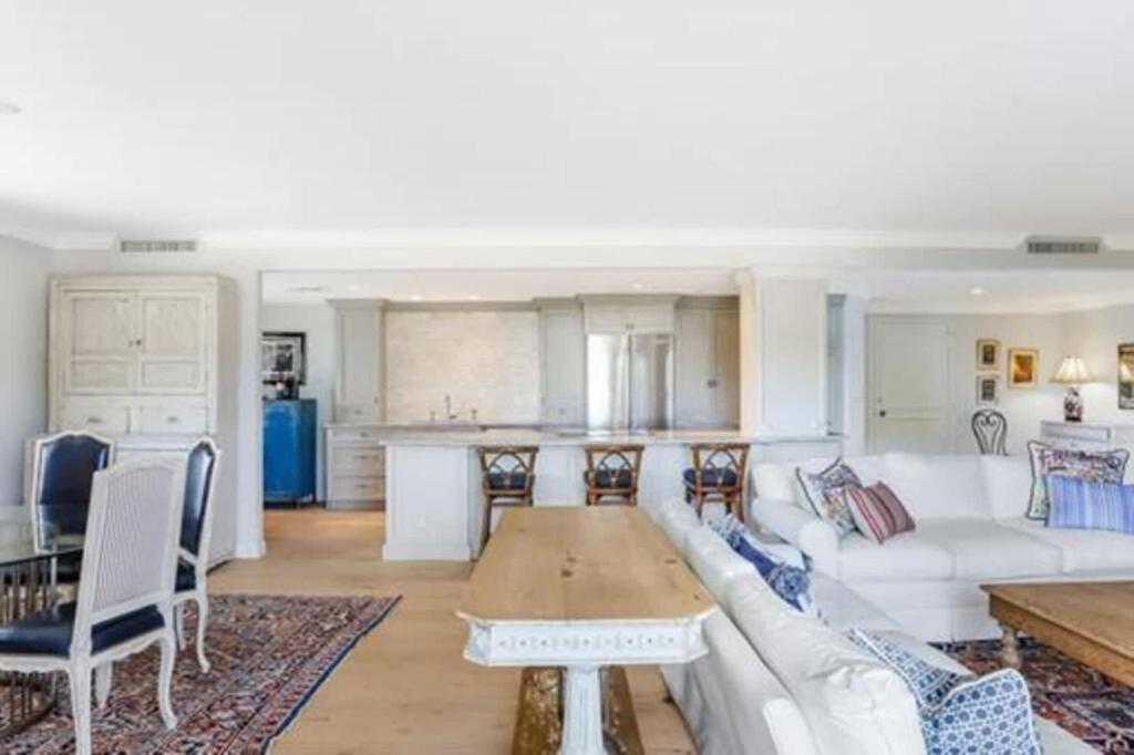 a living room with a white couch and a table at Two Bedroom Bayfront Condo with Water Views in Naples