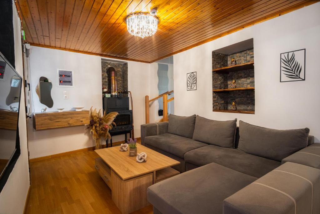 a living room with a couch and a table at Joanna's House in Koumaradaíoi