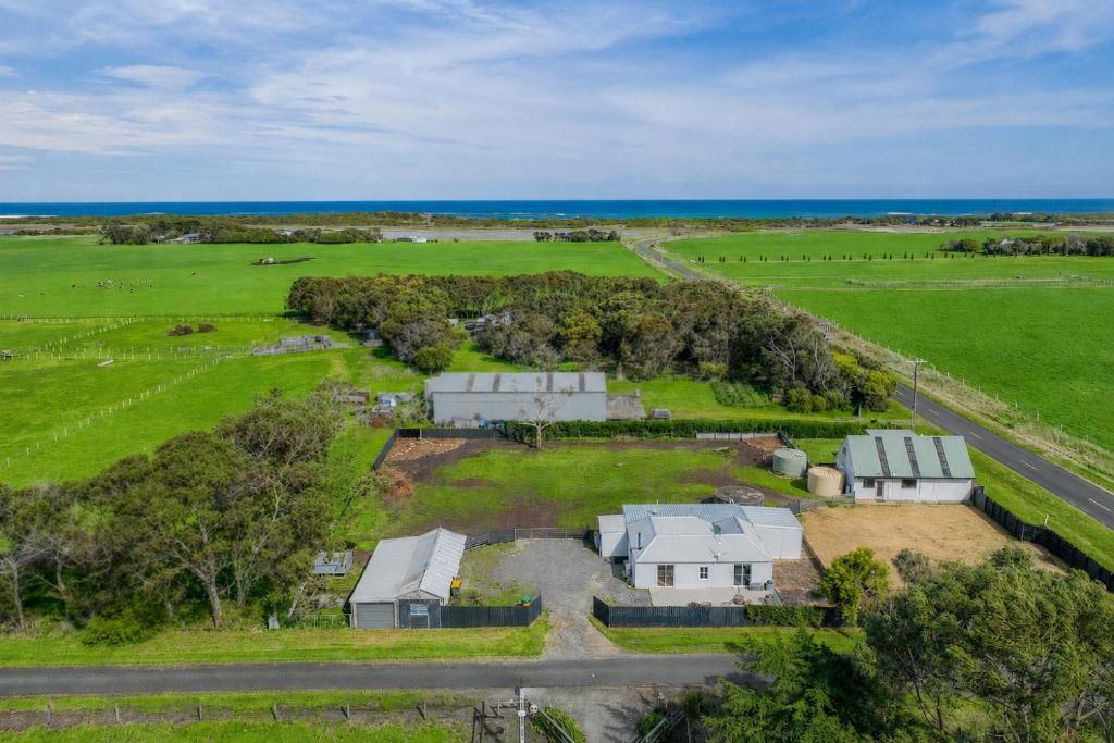 an aerial view of a farm with buildings and the ocean at Tranquillity by the sea in Killarney