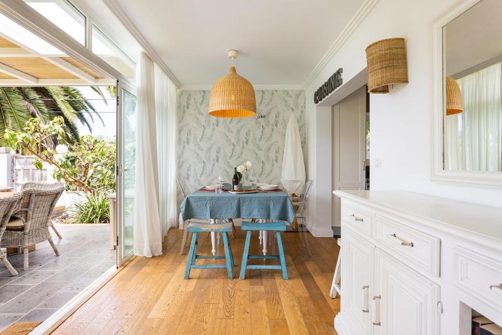 a kitchen with a blue table and two stools at Views Spacious Villa in El Rincón