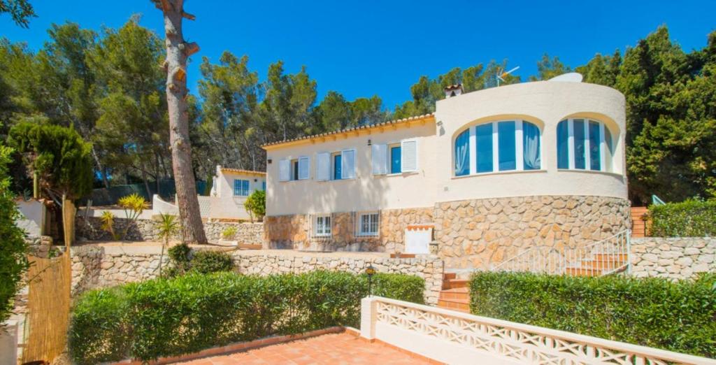 a house with a stone wall at Villa SOFIA - Costa Blanca in Benissa