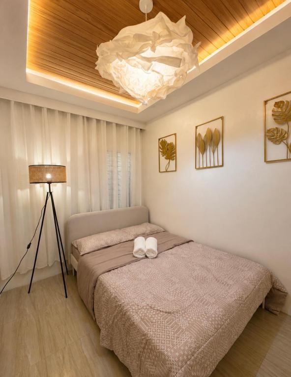 a bedroom with a bed and a light at Casa Aelliah in General Santos