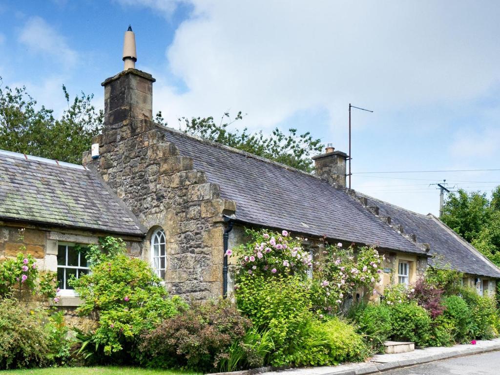 an old stone house with a black roof at Wanton Wa's in Edinburgh