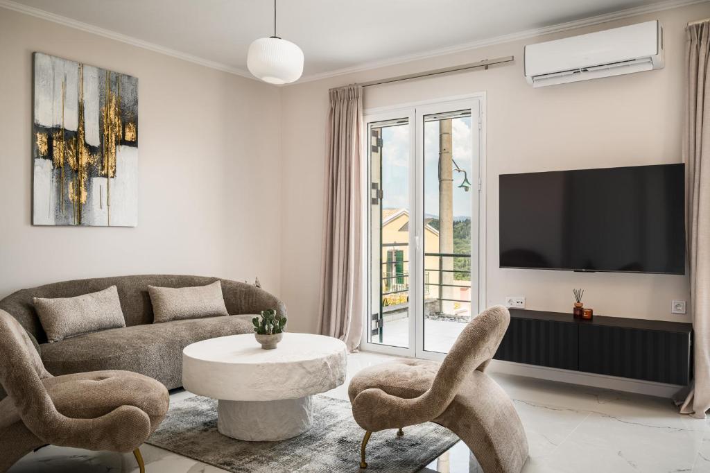 a living room with a couch and a table and chairs at Althaia Three-Bedroom Maisonette by Konnect in Corfu