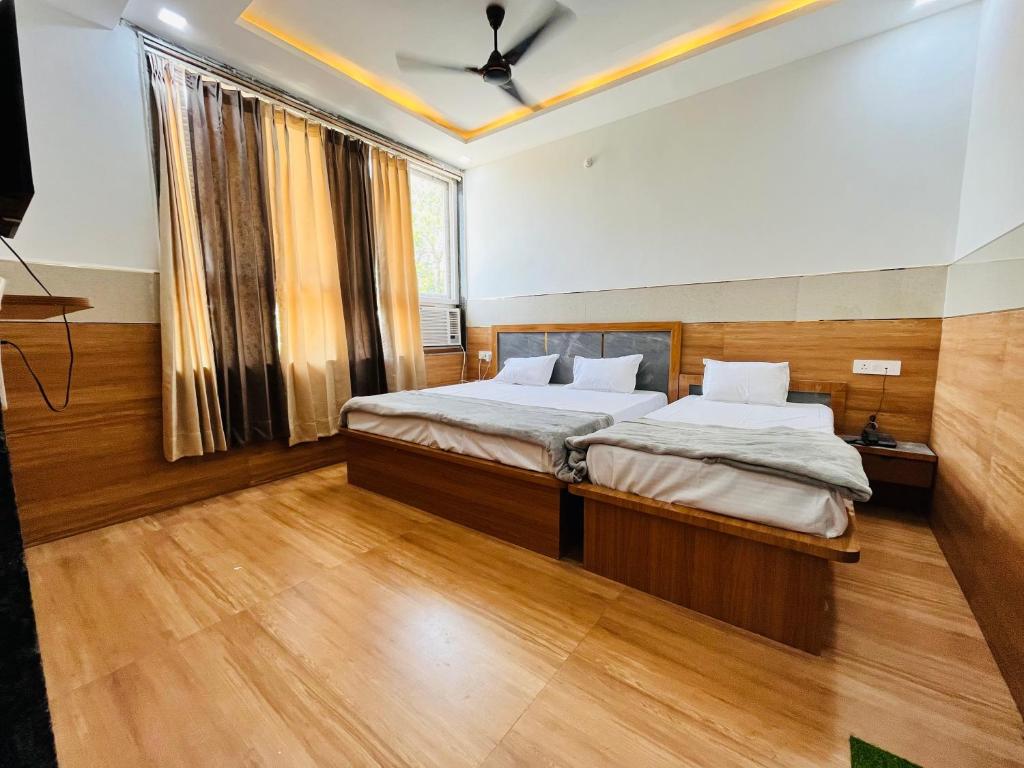 a bedroom with a bed and a large window at Hari Kamal Invitation in Mathura