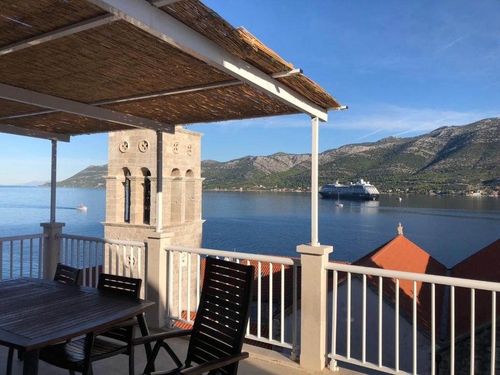 a balcony with a table and chairs and a view of the water at Marko Apartment in Korčula