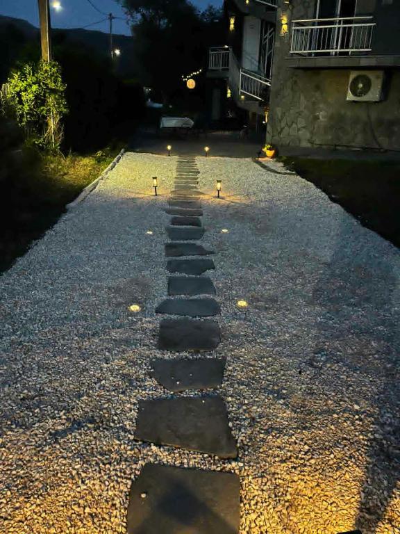 a stepping stone path in the middle of a driveway at Vesper Rooms in Skala Prinou