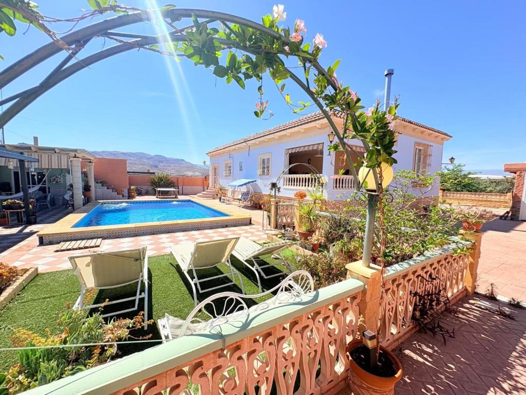 a villa with a swimming pool and a house at Villa Mansa in Pechina