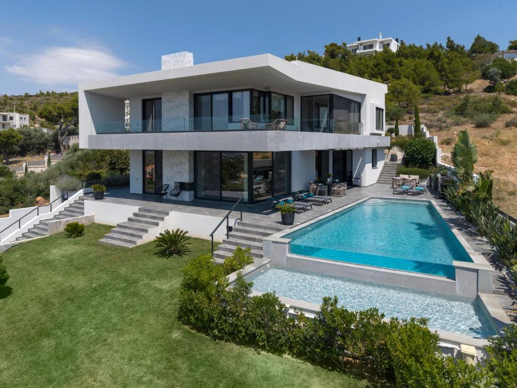 an aerial view of a house with a swimming pool at Aurora Residence by A&D Properties in Neos Voutzas