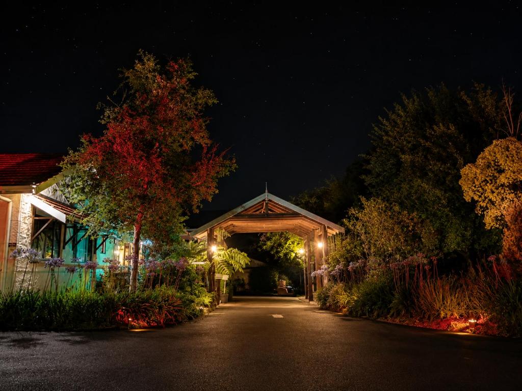 a house with a lit up archway at night at Karri Forest Motel in Pemberton