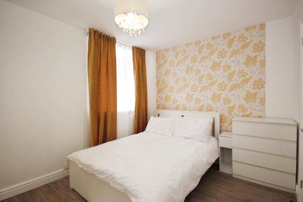 a bedroom with a white bed and a chandelier at APod in Coventry