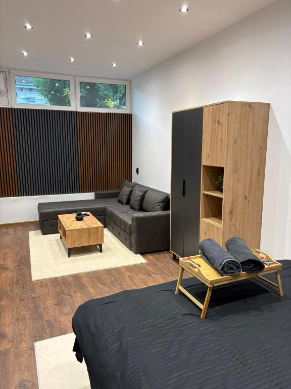 a living room with a couch and a table at La Luna Apartman in Bečej